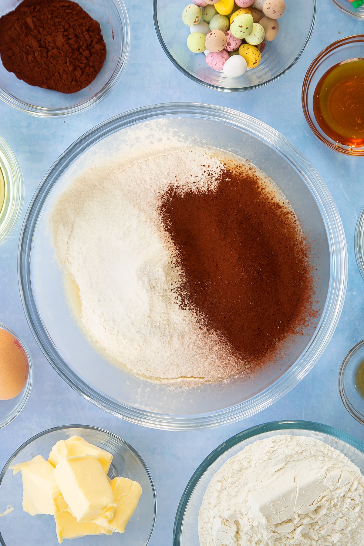 Adding flour, cocoa and bicarbonate of soda to the cake mixture.