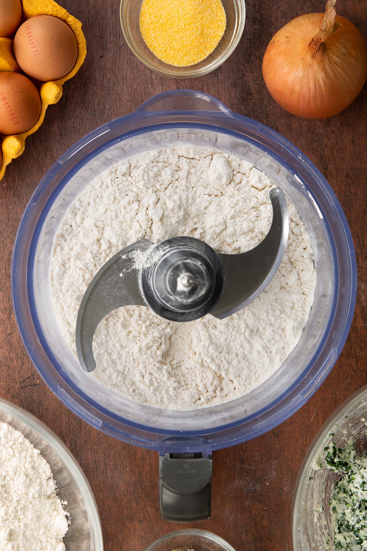 Overhead shot of flour inside a food mixer.