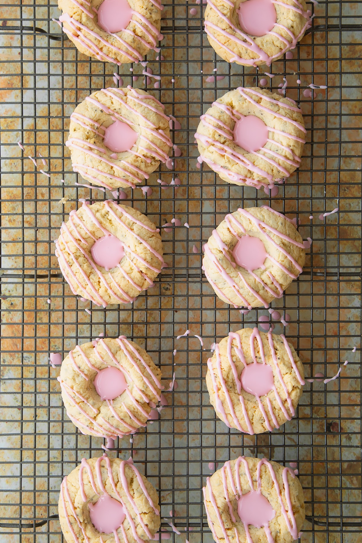 Overhead shot of the pink icing sugar having been squeezed into the centre of the cookies.