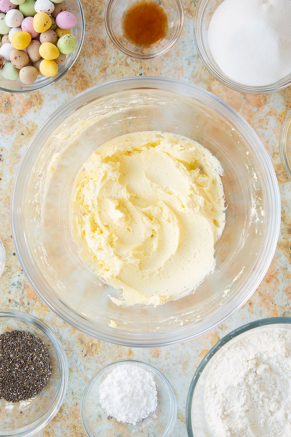 Overhead shot of butter and sugar having been whisked together in a mixing bowl.