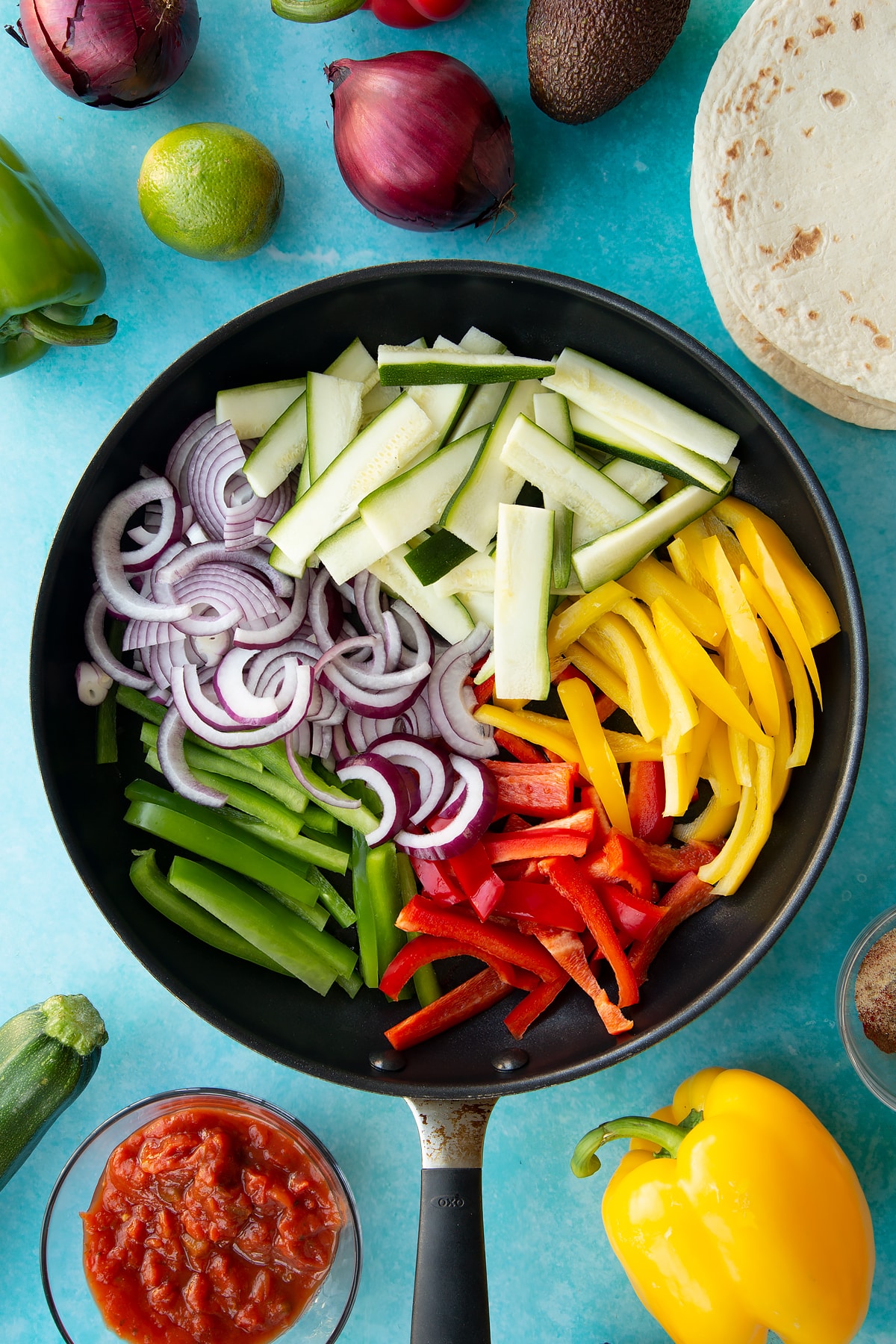 Sliced vegetables in a pan with oil.