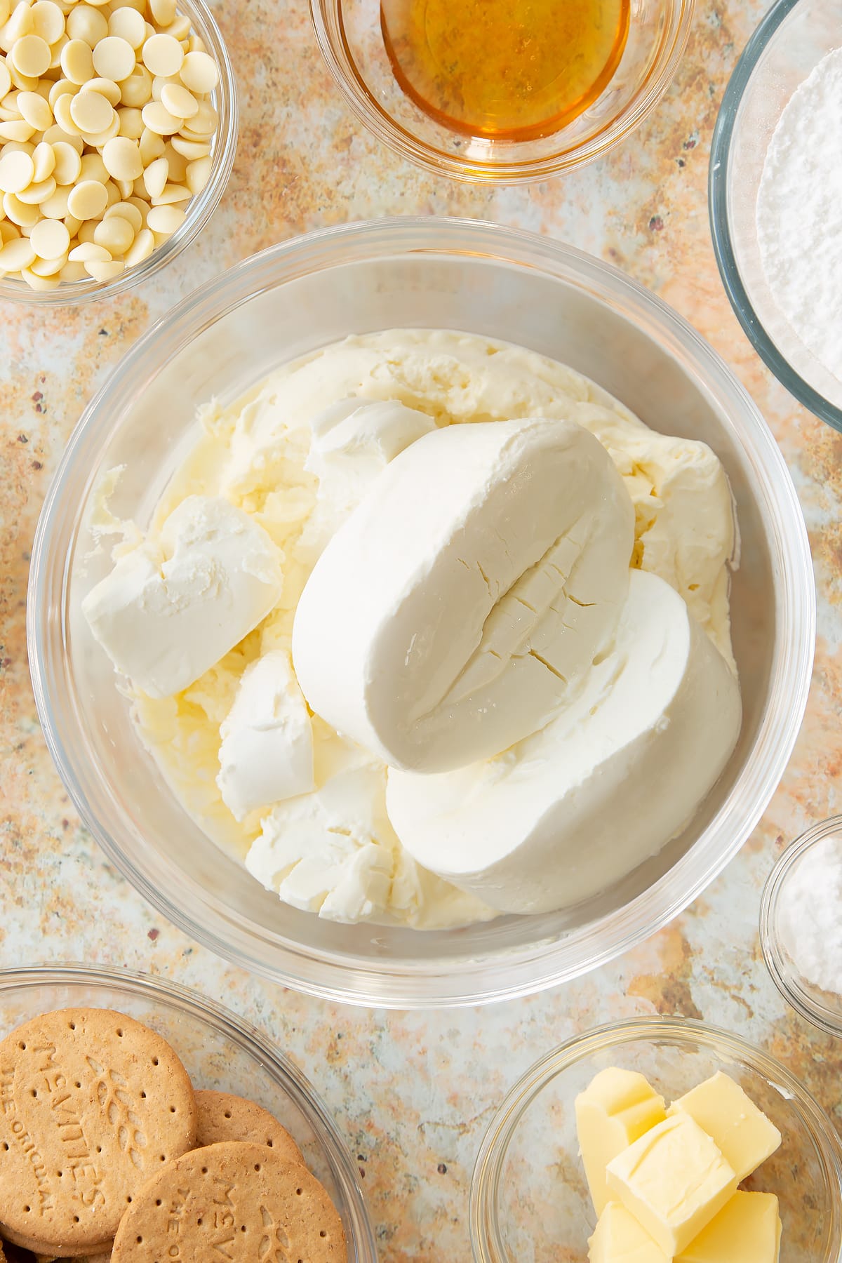 Whisked double cream and icing sugar in a large bowl topped with cream cheese.