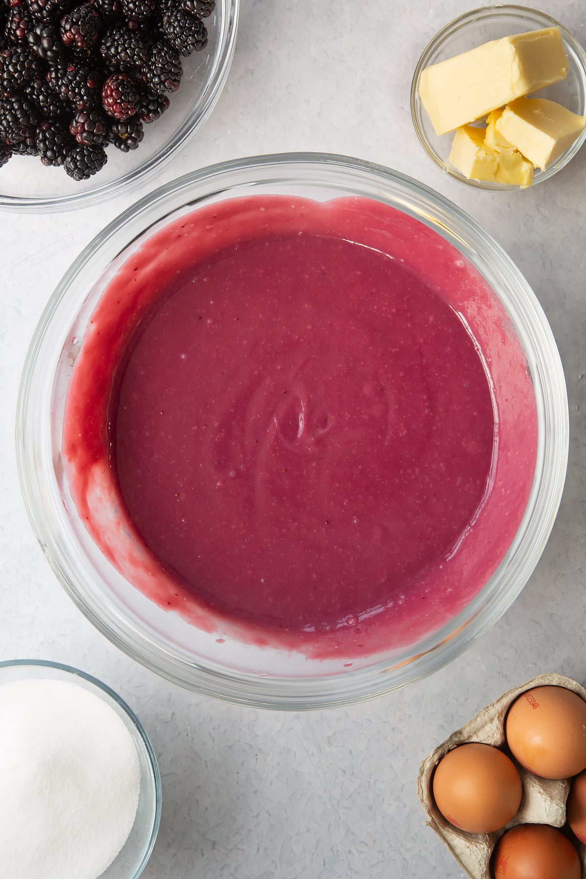 thickened blackberry juice mixture in a large clear bowl.