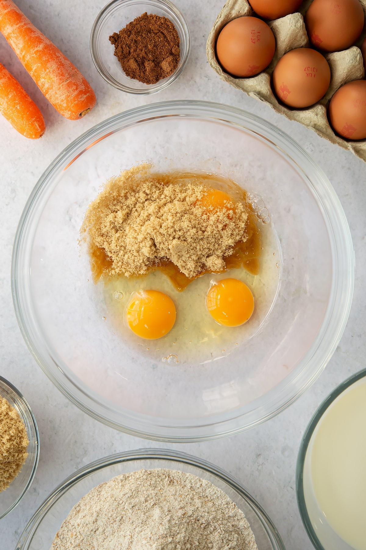sugar and 2 eggs in a large clear bowl.