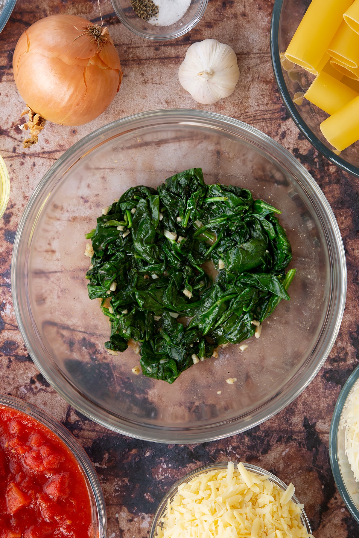Overhead shot of spinach cooling inside a bowl.