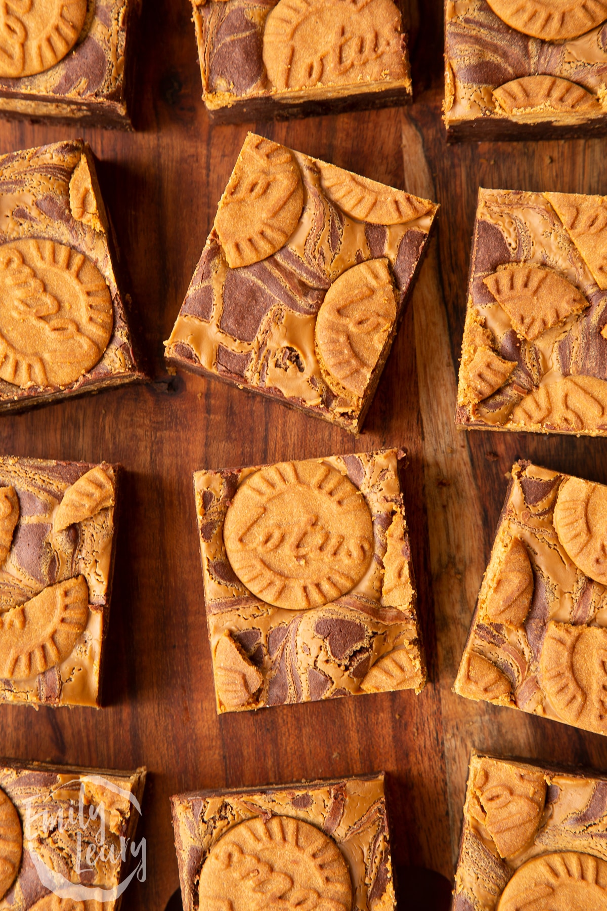 square biscoff brownies on a wooden chopping board.