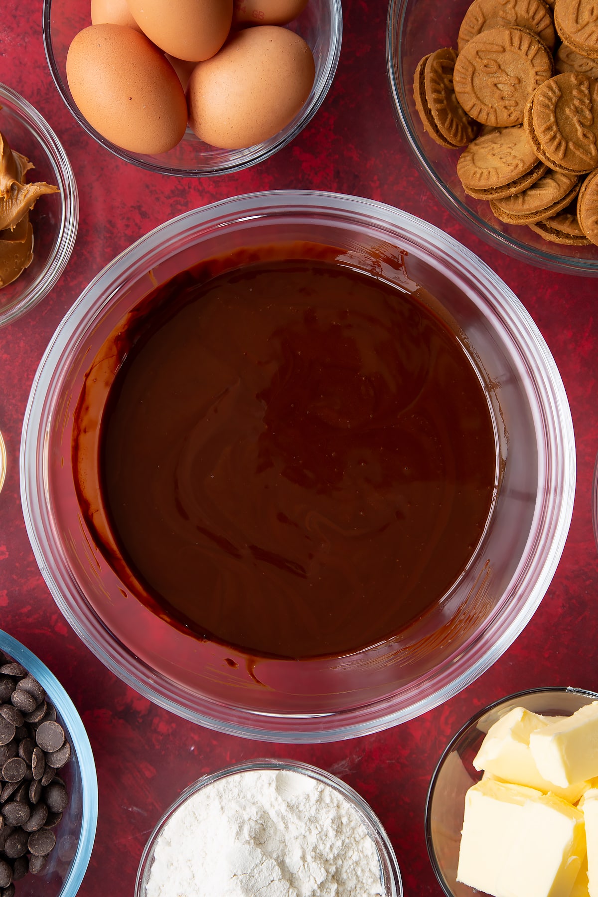melted butter and dark chocolate in a large clear bowl.