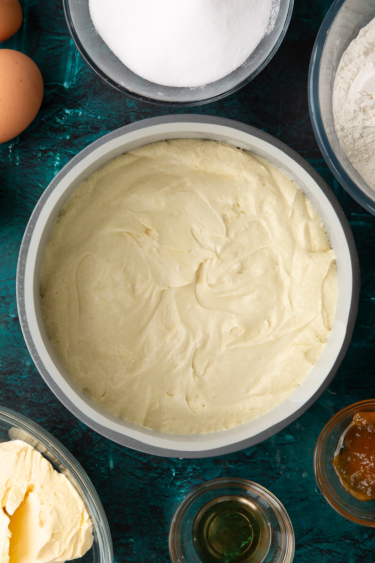 whisked cake batter in a lined cake tin.