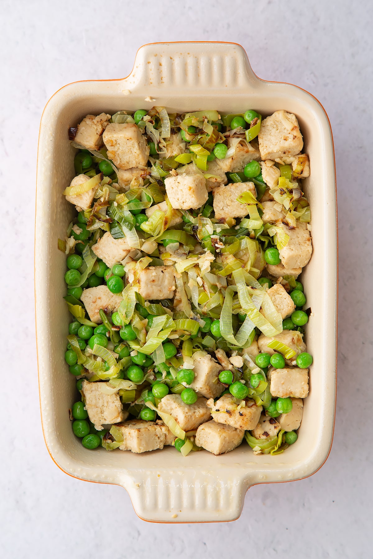 leek and vegerarian style chicken mix in a small greased roasting tray.