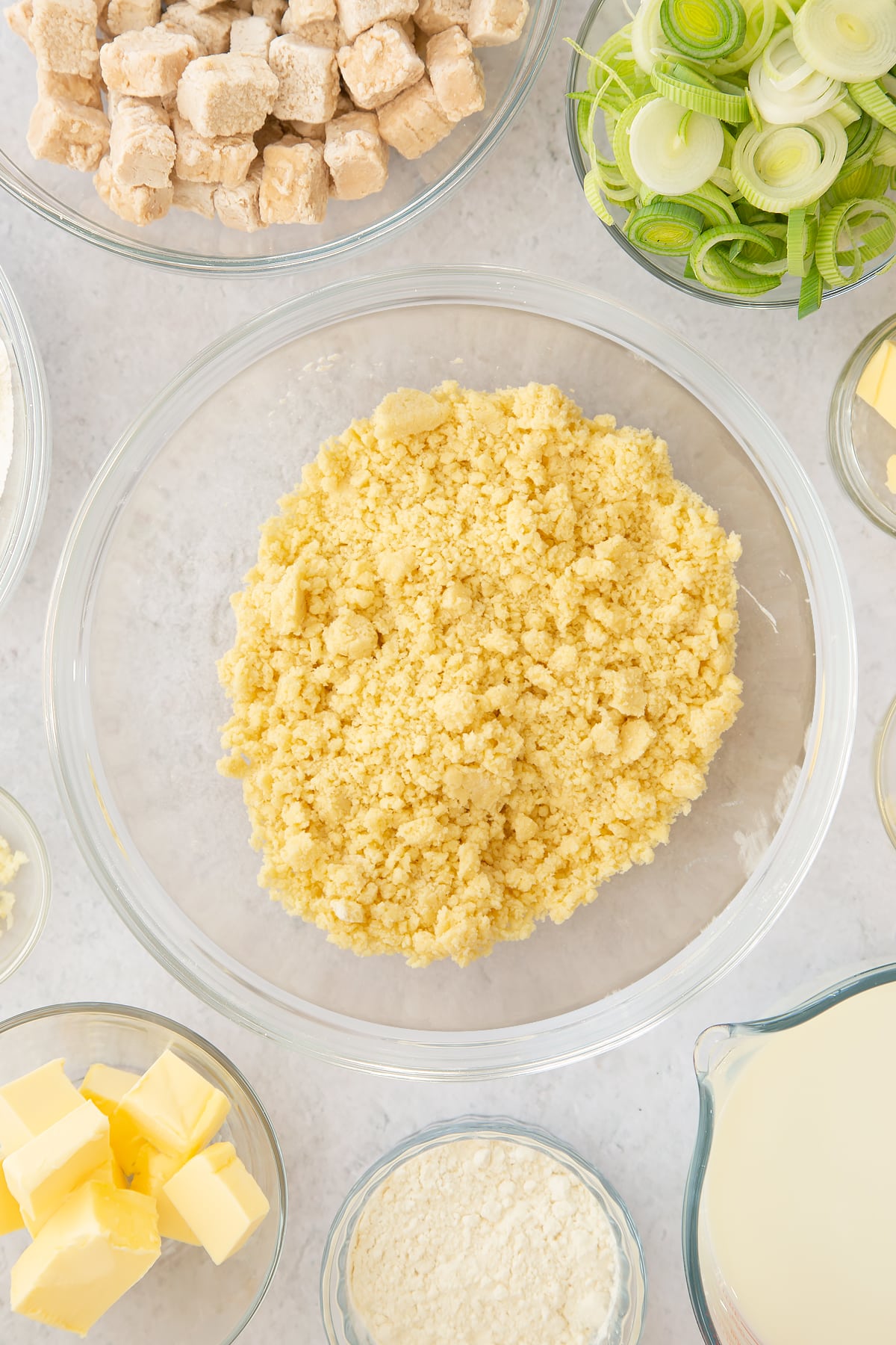 butter and flour crumbled mix in a large clear bowl.