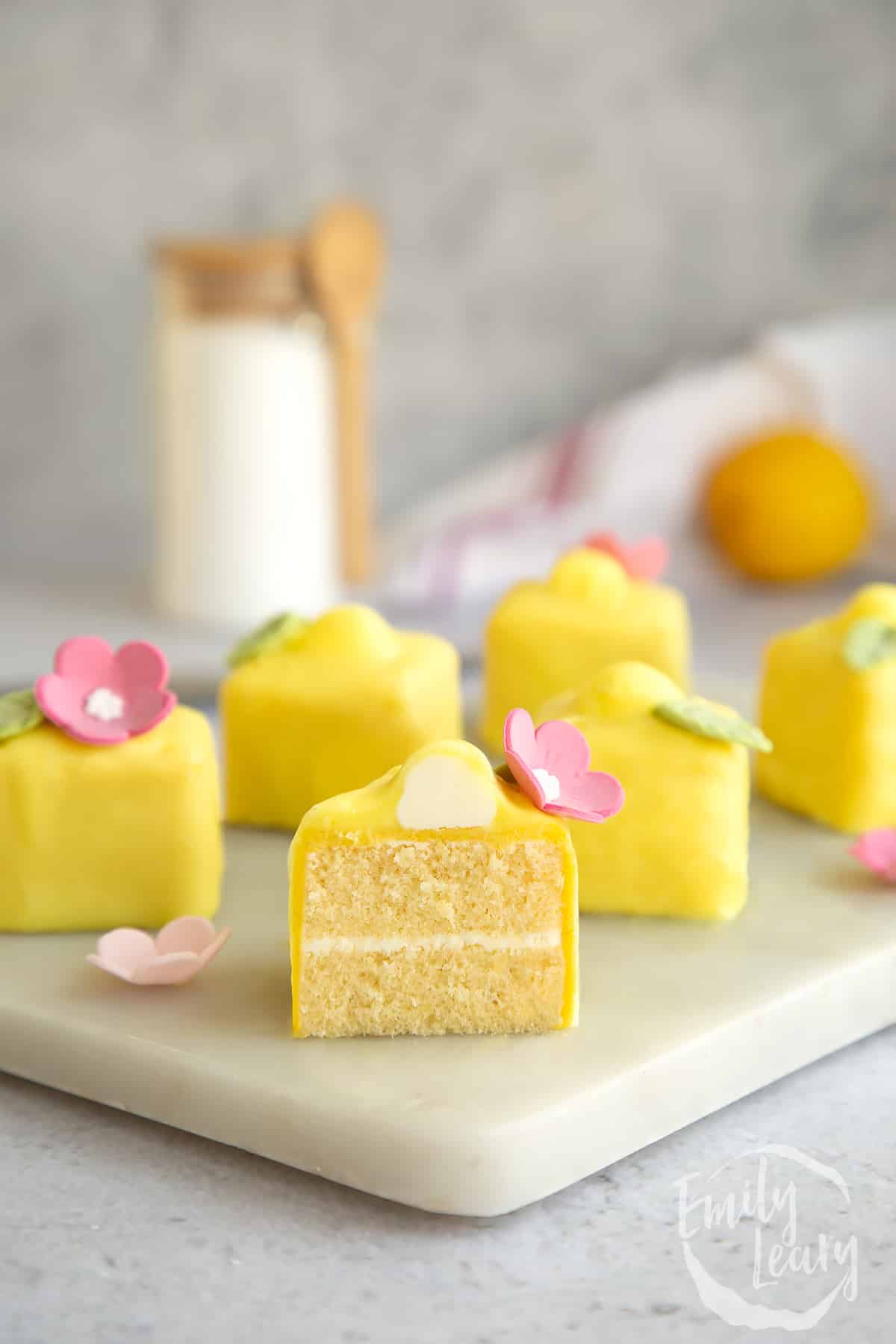 A sliced open lemon fondant fancie on a marble board.