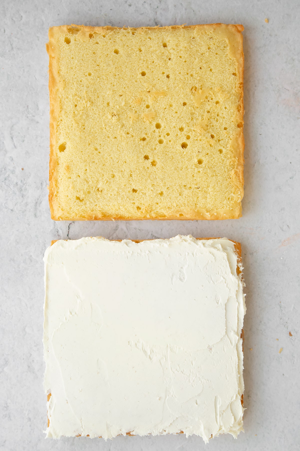 Spreading a thin layer of butter cream onto the sponge.