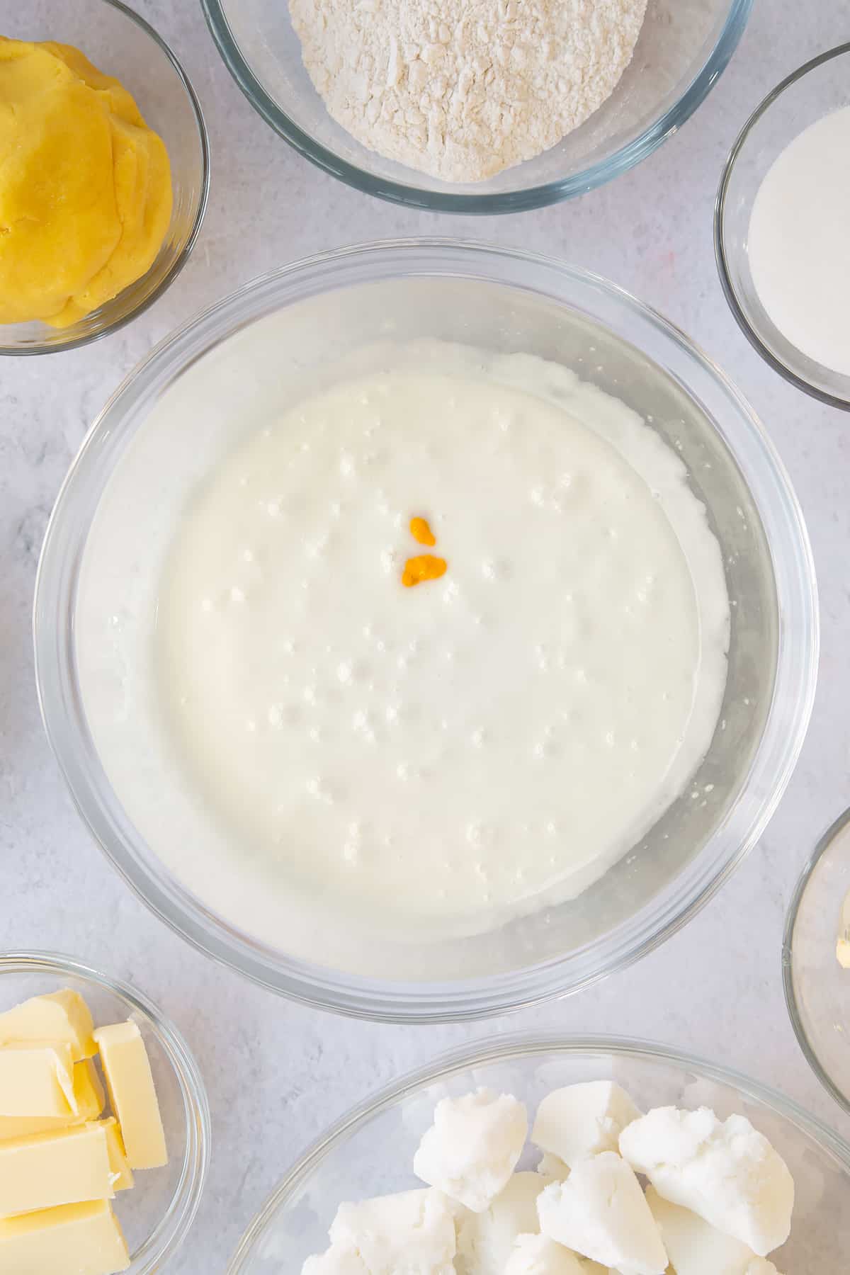 Adding the lemon extract to the icing.