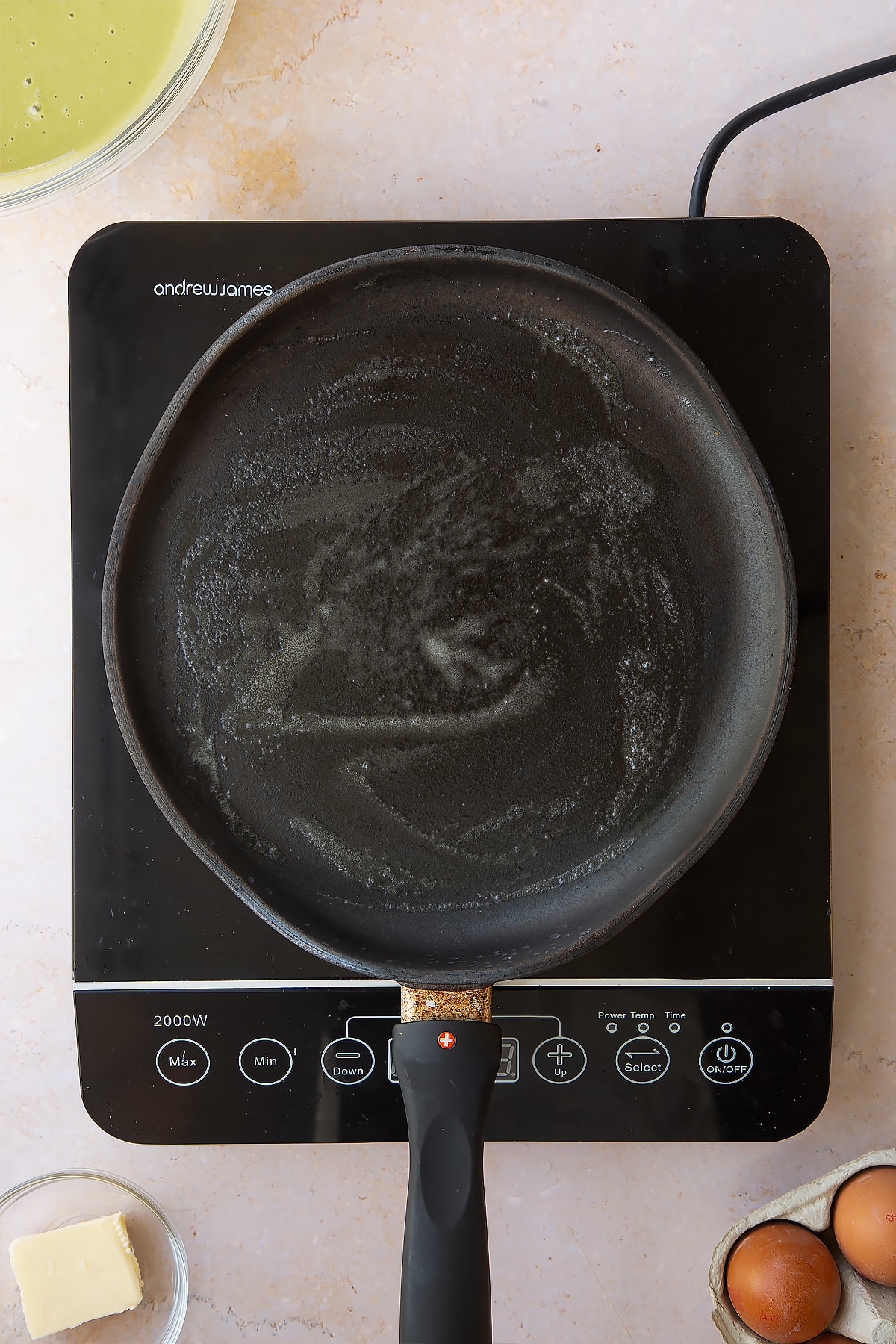 melted butter in a frying pan on an induction hob.