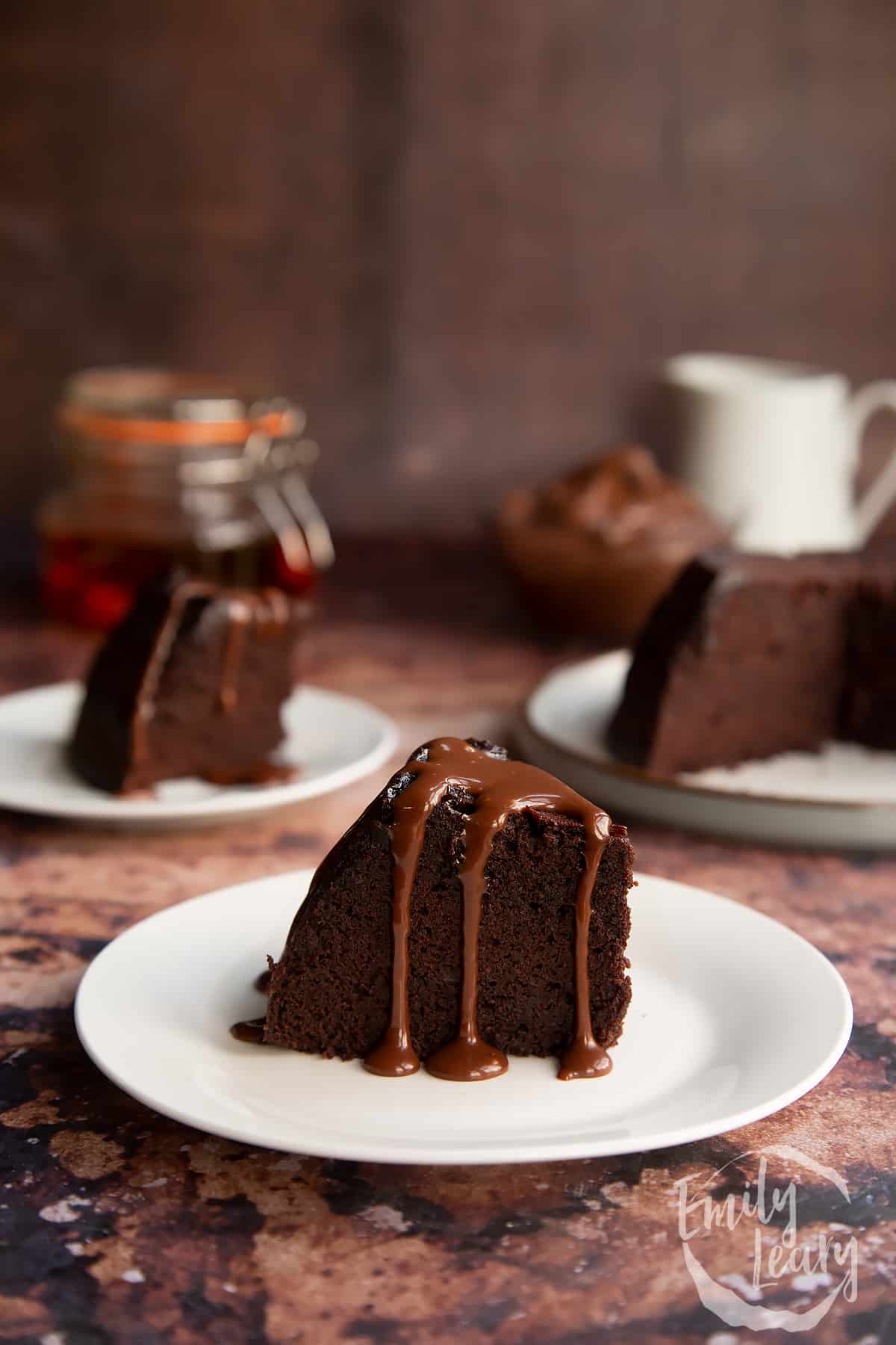 a slice of Nutella pudding cake on a white plate drizzled with nutella sauce.