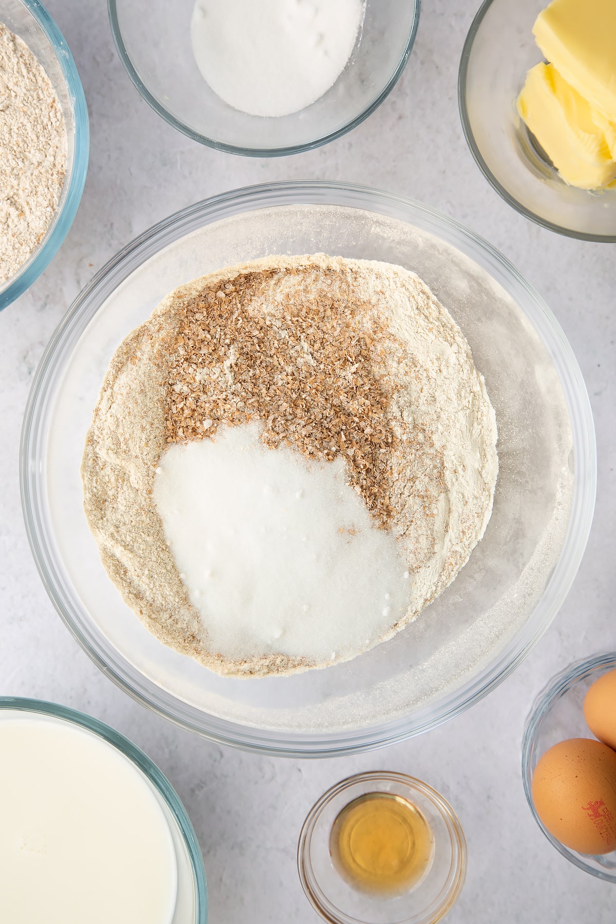 wholemeal flour and sugar in a large clear bowl.