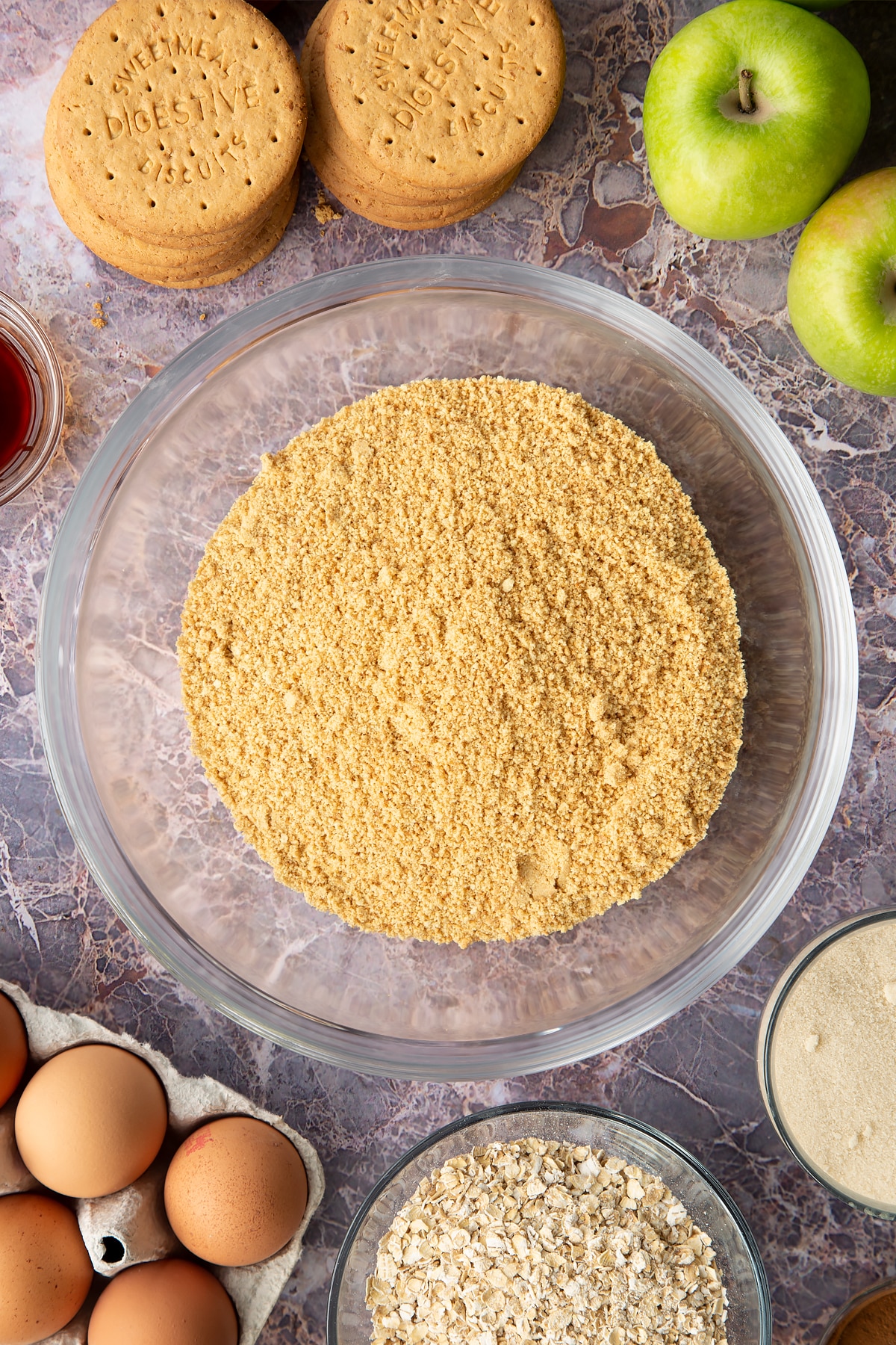 Crushed biscuit crumbs in a mixing bowl.