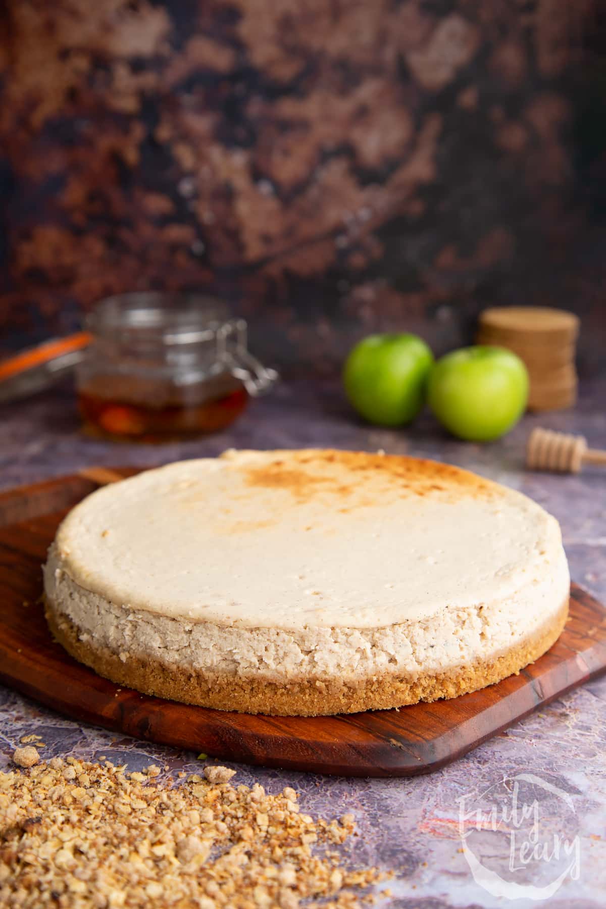 Side on shot of the cheesecake having been left to cool. Served on a wooden board.