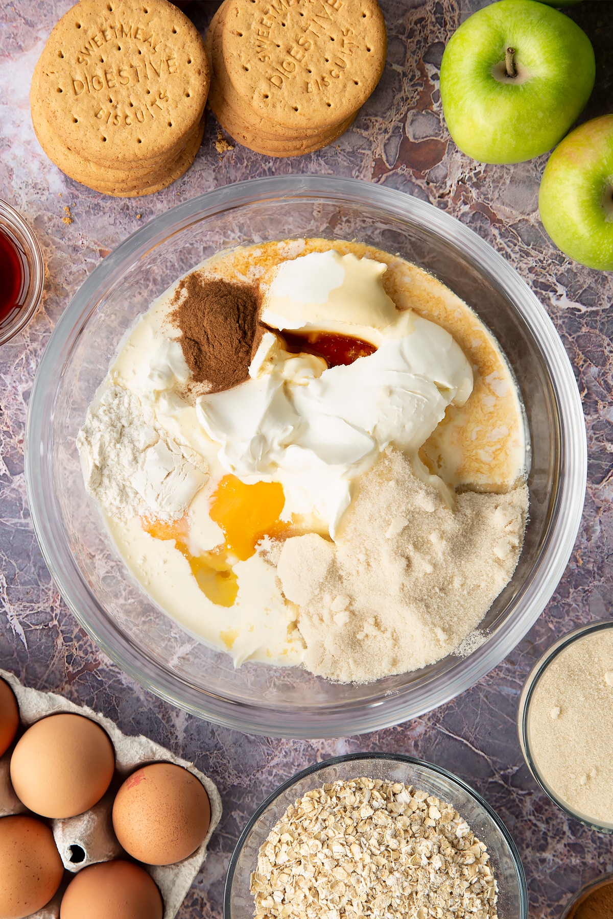Adding cream cheese, double cream, vanilla, eggs, plain flour, cinnamon and golden caster sugar into a bowl.