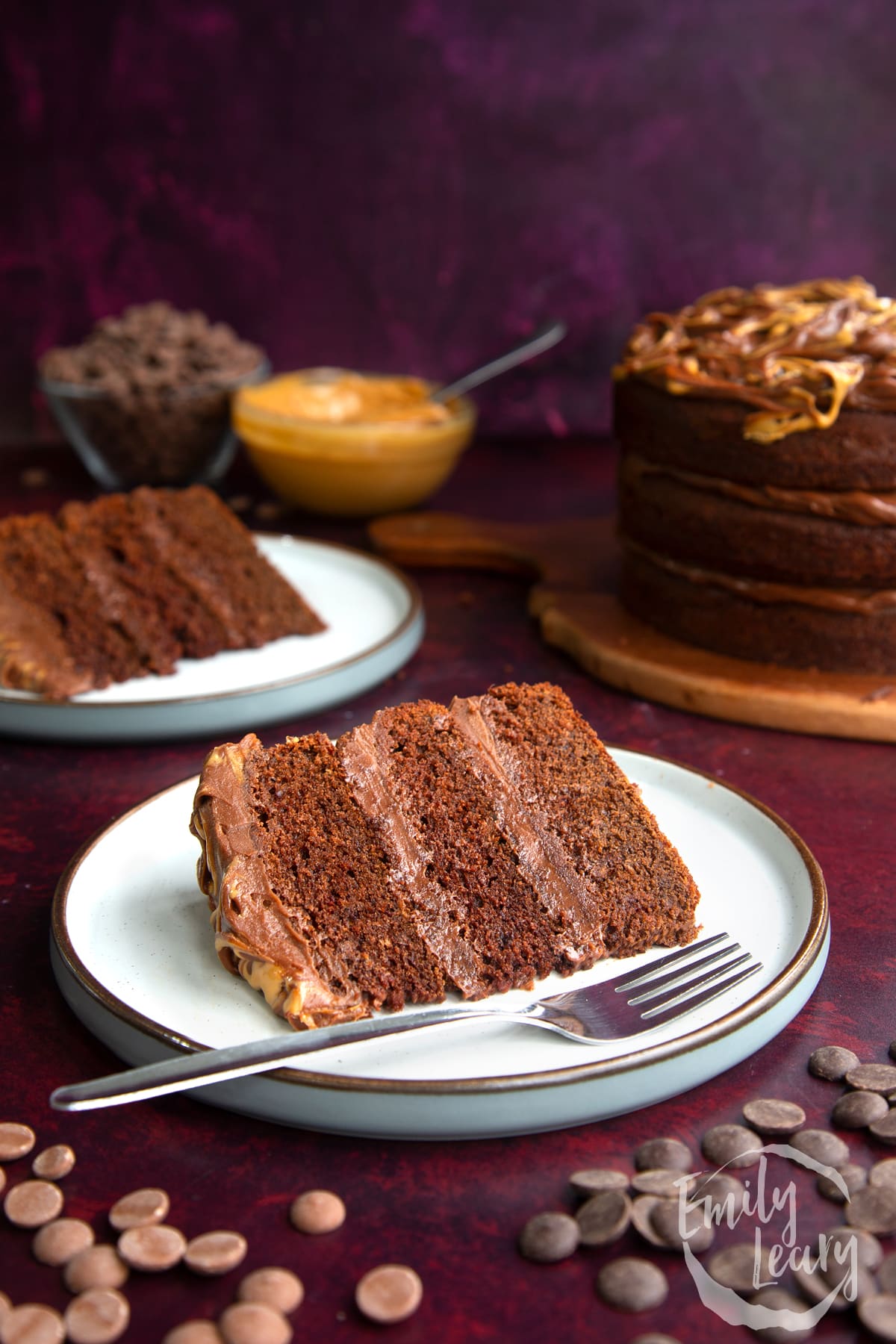 a piece of Peanut butter fudge cake on a white plate with a fork on the side.