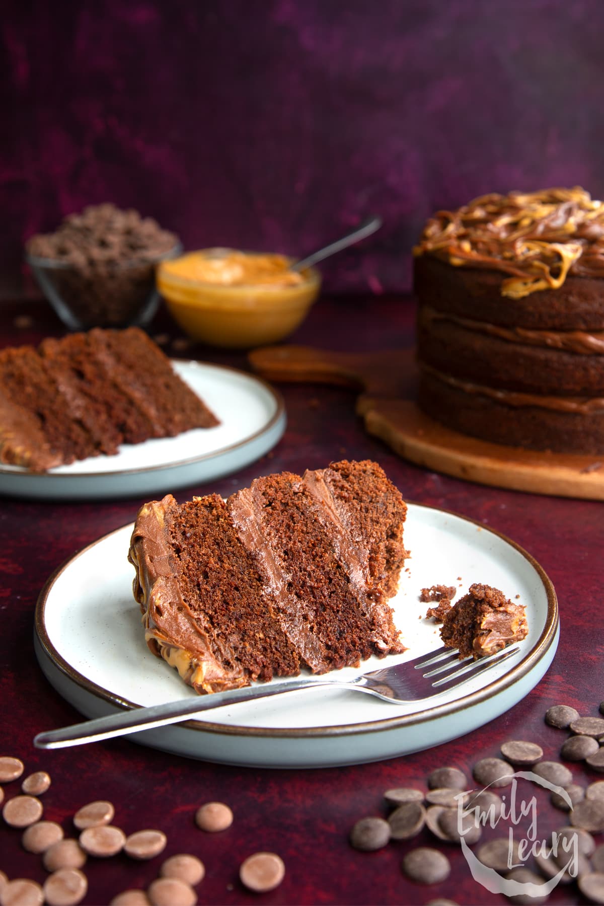 a piece of Peanut butter fudge cake on a white plate with a fork with a bite on the end.