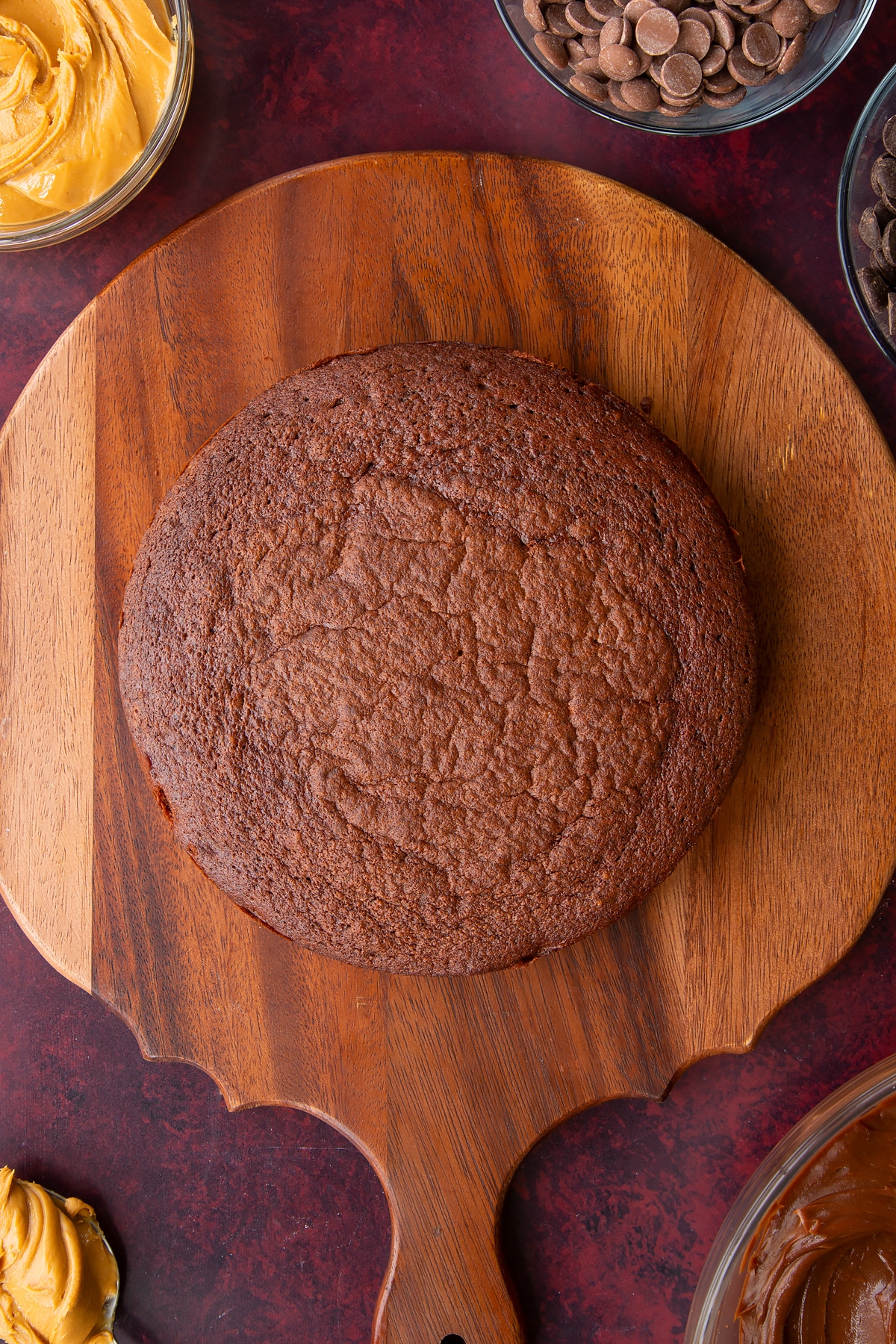 cooked chocolate peanut butter cake on a wooden chopping board.