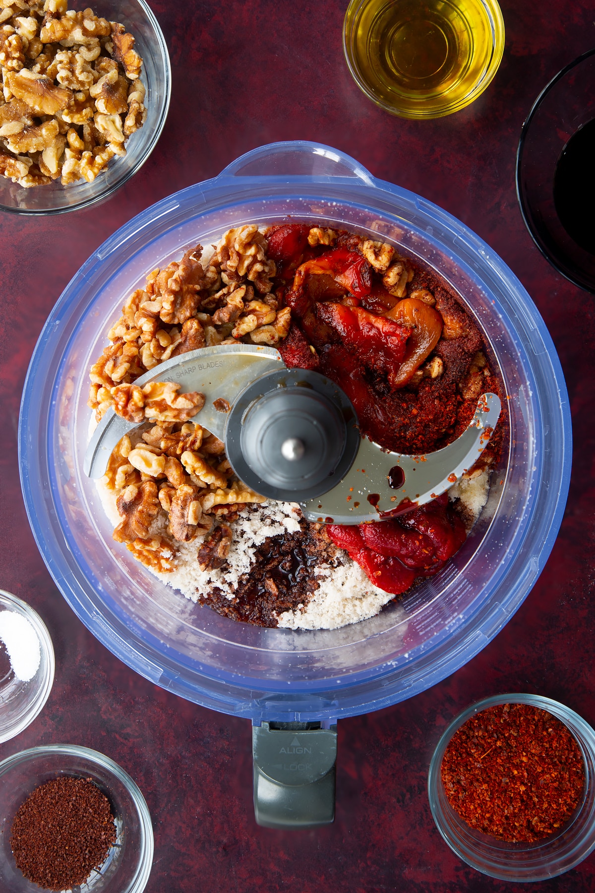 peppers, walnuts, olive oil, tomato puree, Aleppo pepper, pomegranate molasses, sumac in a food processor.
