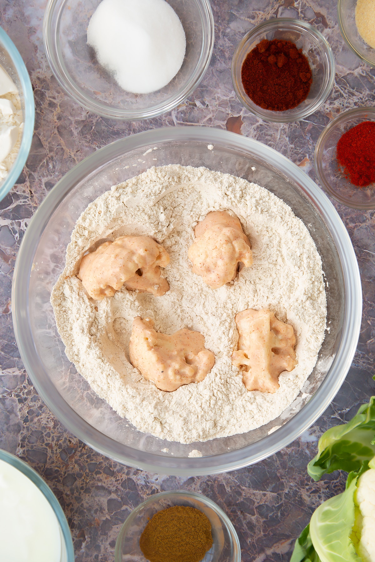 buttermilk marinated cauliflower pieces in flour spice mix.