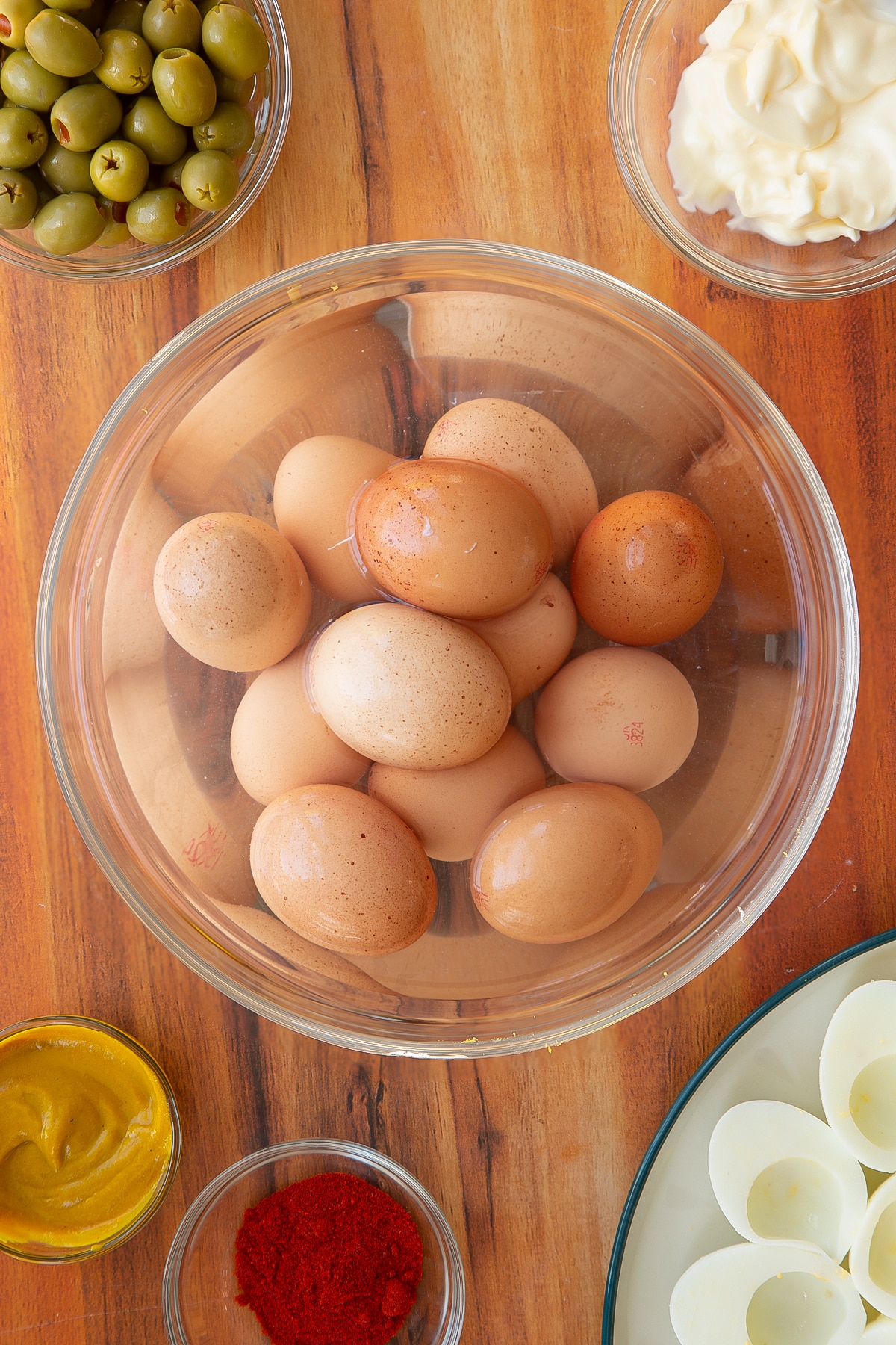 A large batch of eggs in an ice bath having been brought to the boil.
