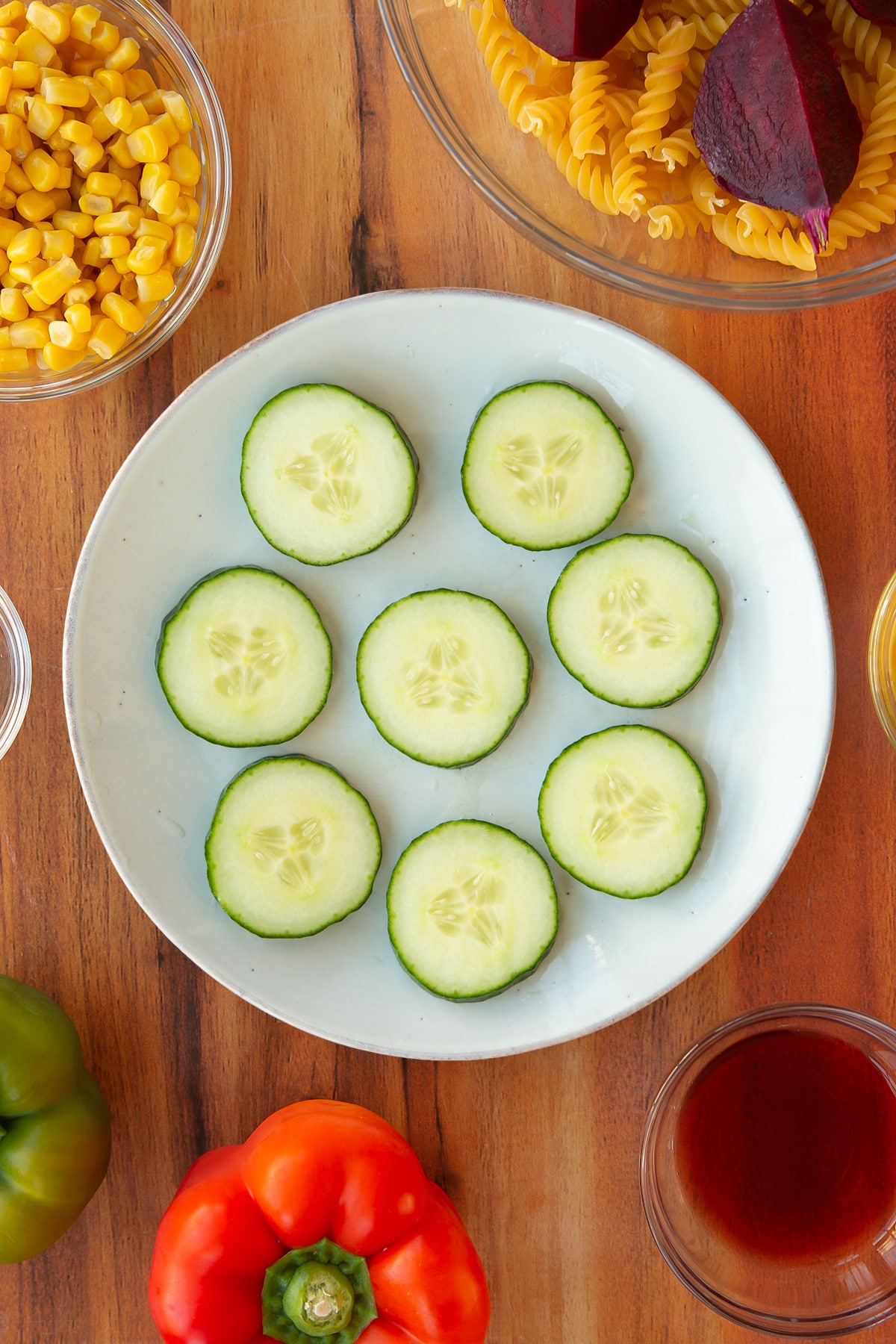 Cucumber slices on a white decorative plate.