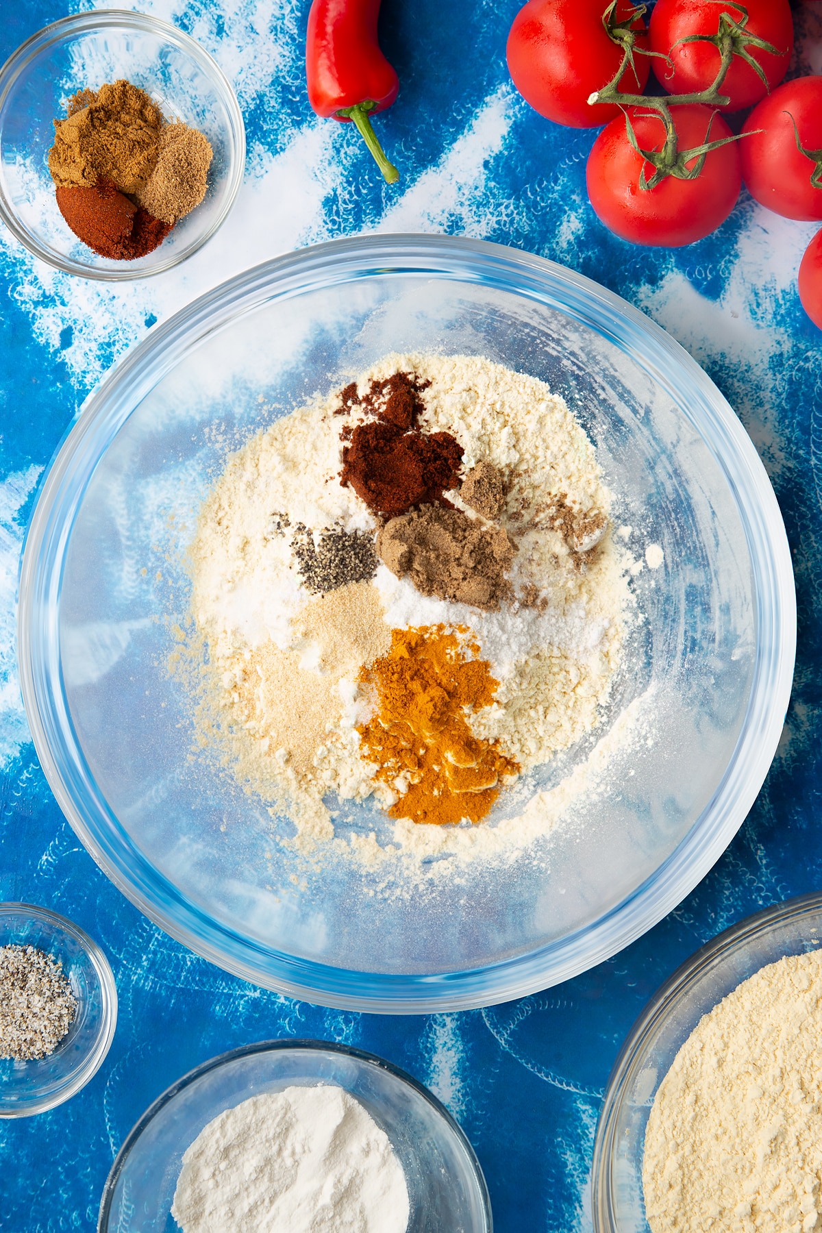 Overhead shot of a bowl filled with ingredients for the tomato pakora.